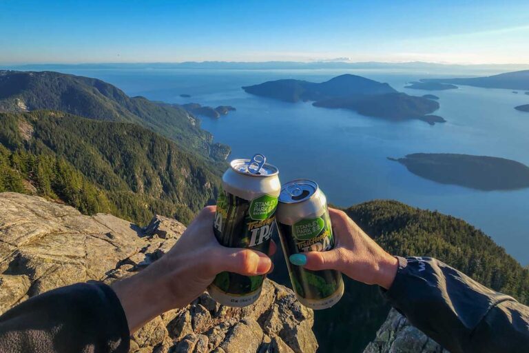 Two people cheers at the top of St Mark's summit in Vancouver