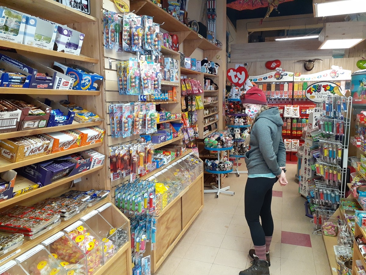 woman shopping inside the Old Tyme Candy Shop in Radium, BC