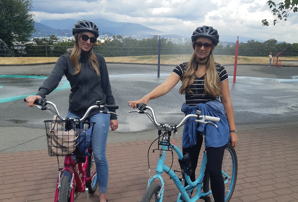 two ladies riding bikes at Stanley Park in Vancouver