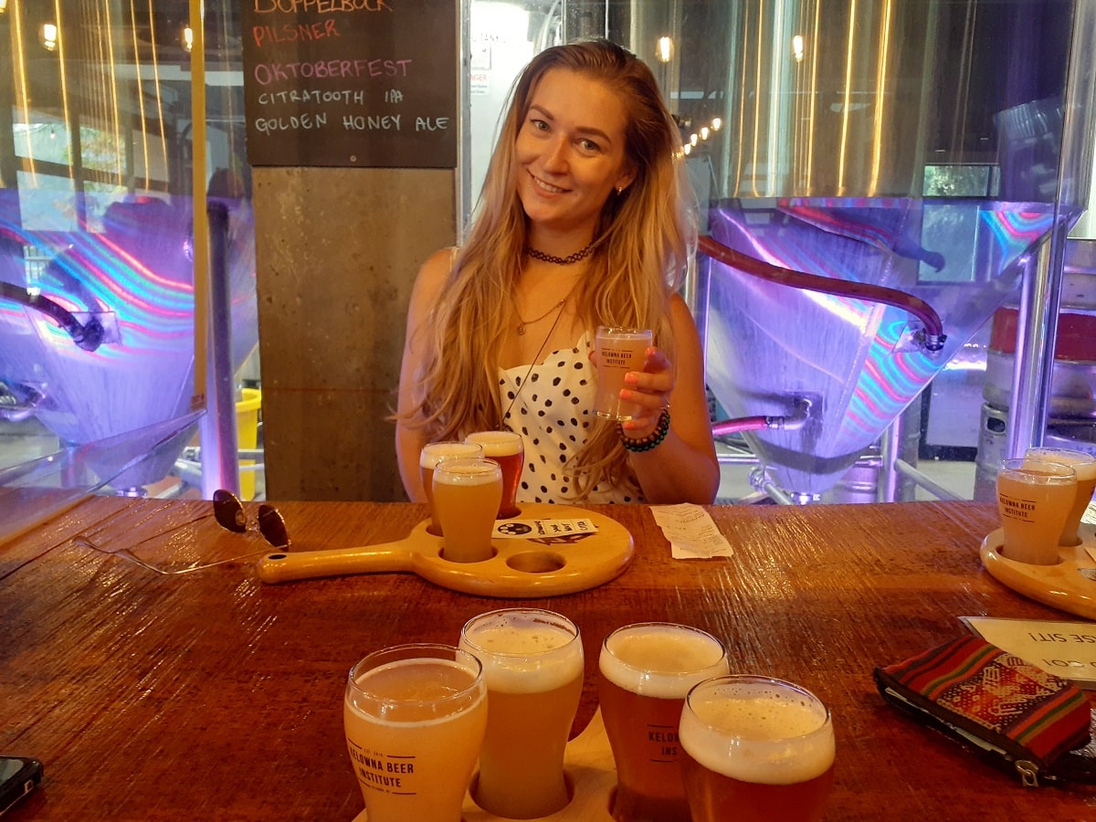 woman drinking craft beer at one of the best breweries in Kelowna