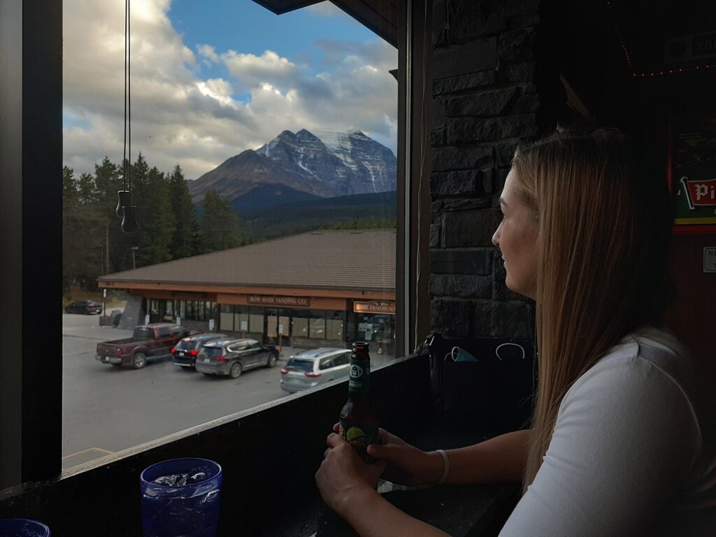 woman enjoying the view from the Village Grill Restaurant in Lake Louise