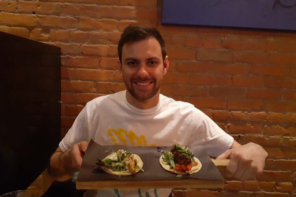 A man poses with his tacos at Navados, Fernie