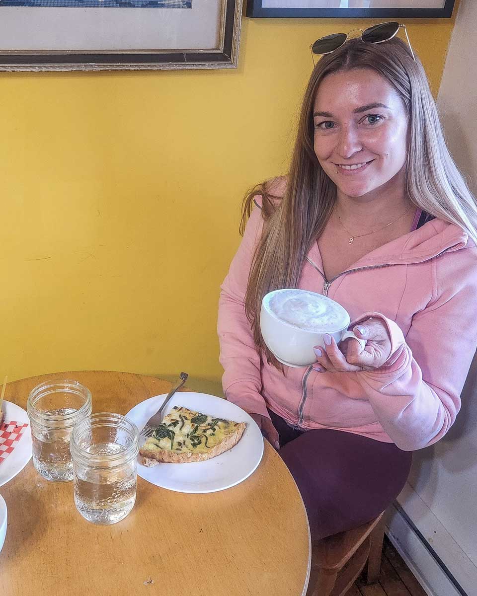 Bailey with a coffee and food at Valemount Swiss Bakery, Valemount