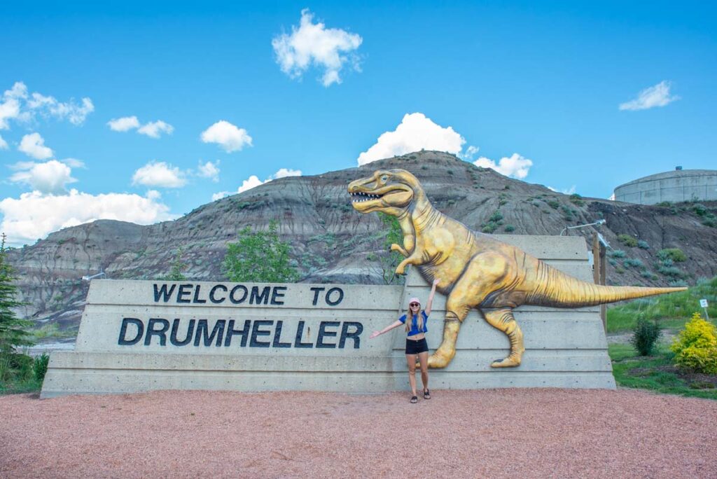 Taking a picture with the "Drumheller" sign