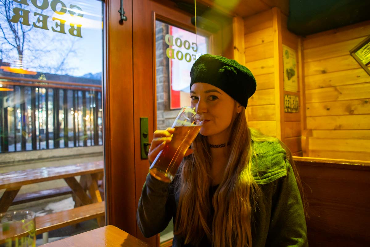 A lady drinks a beer at Tommy’s Neighborhood Pub