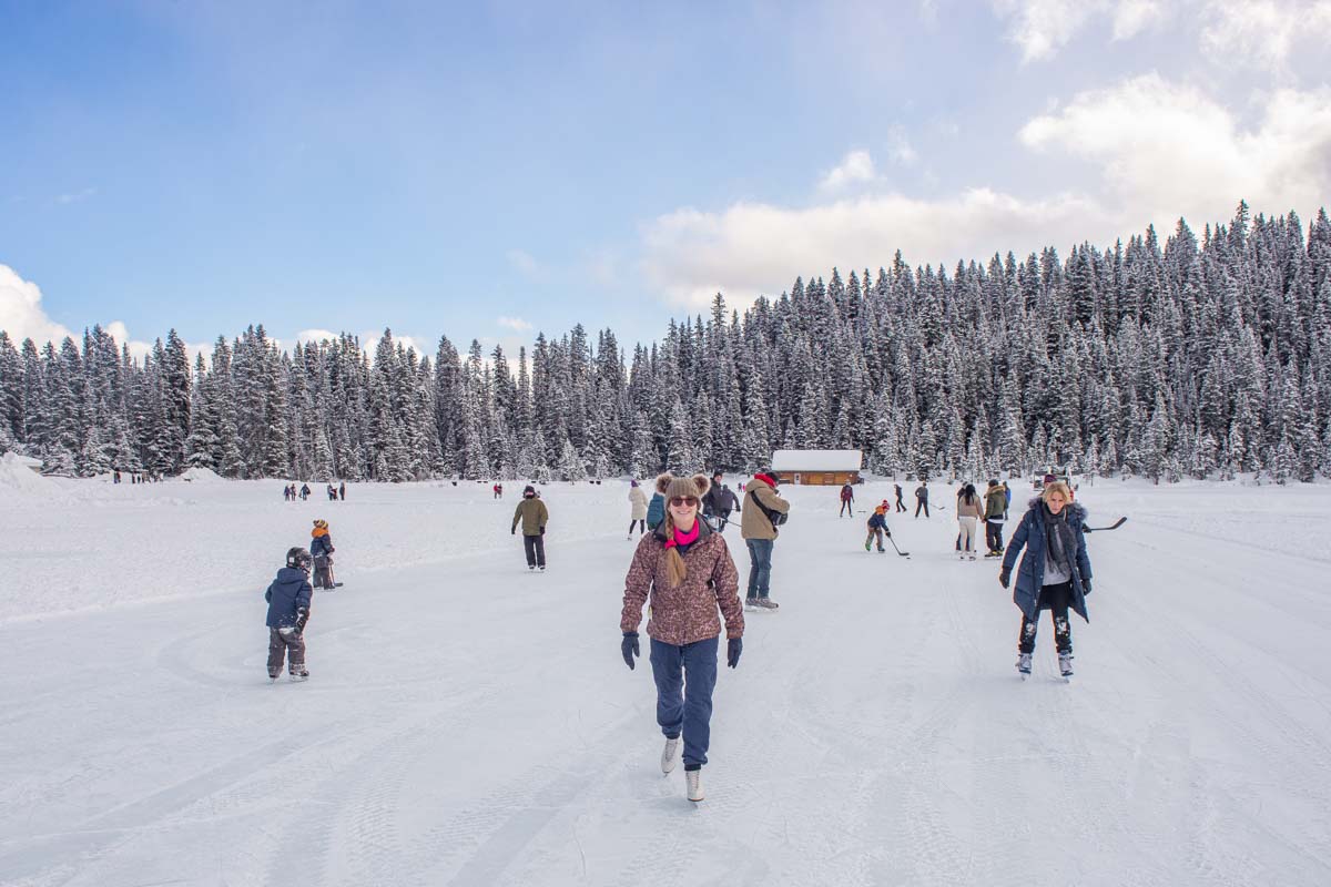 A lady ice skates on Lake Louise