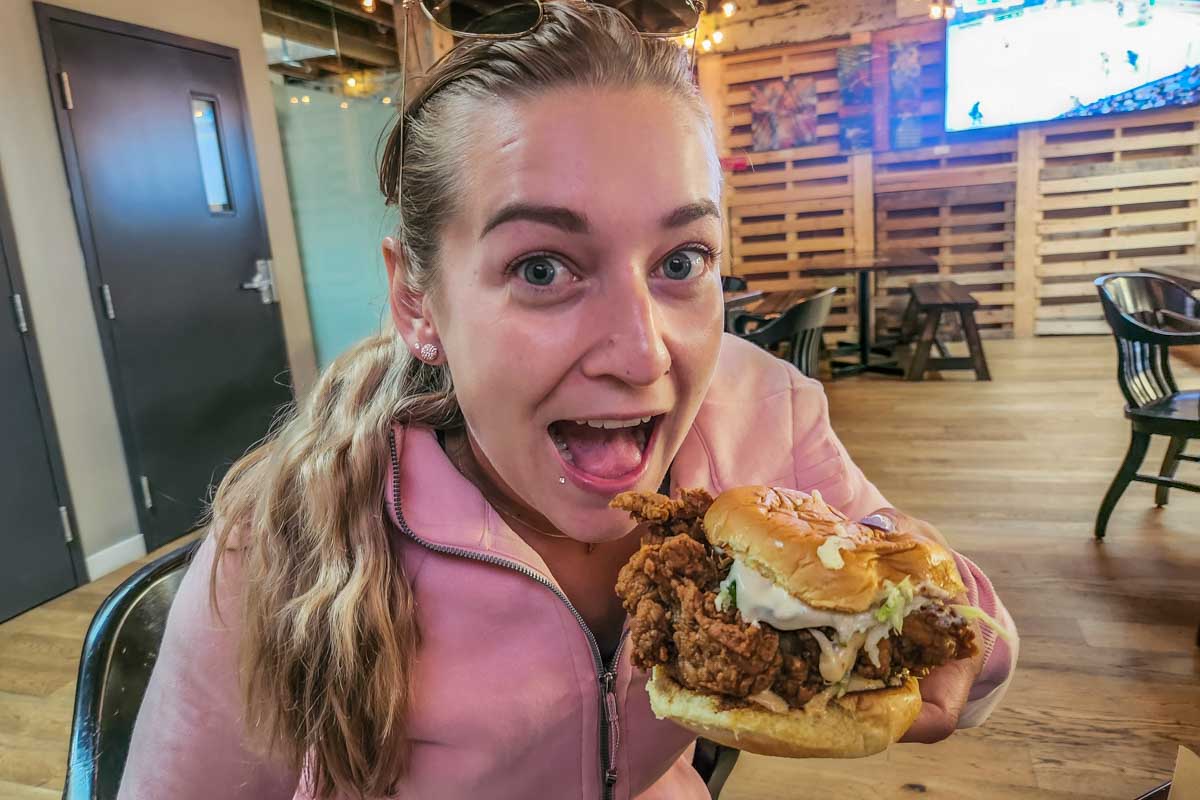 Bailey eats Downlow chicken burger in Vancouver