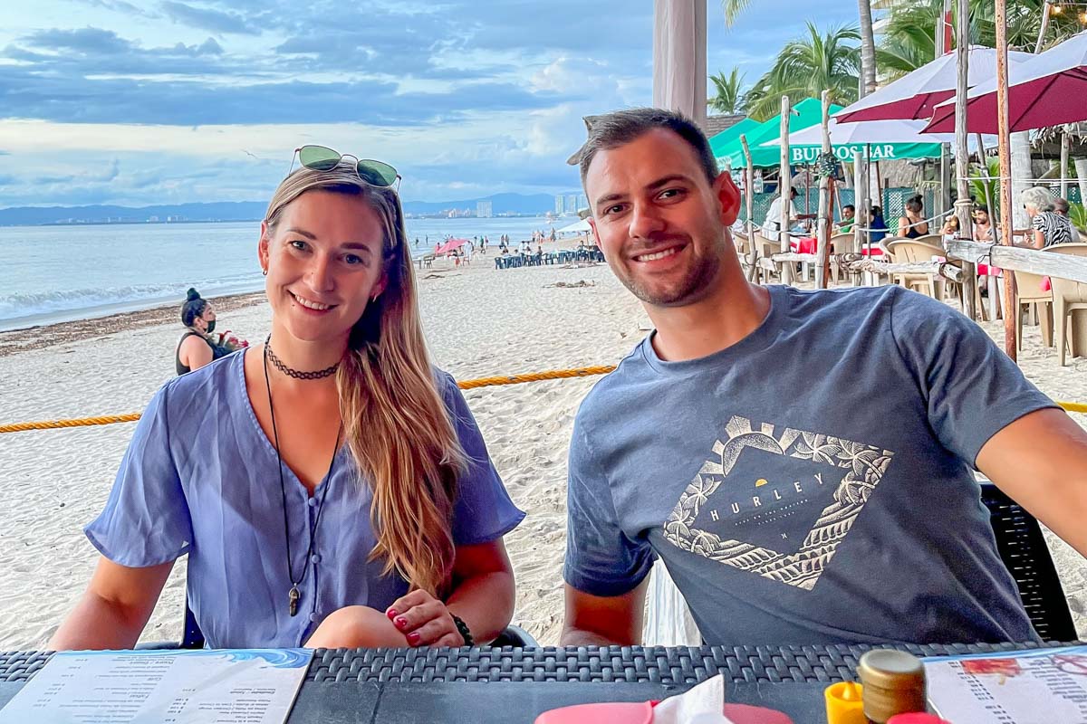 Bailey and Daniel from Destinationless Travel at a restaurant in Puerto Vallarta