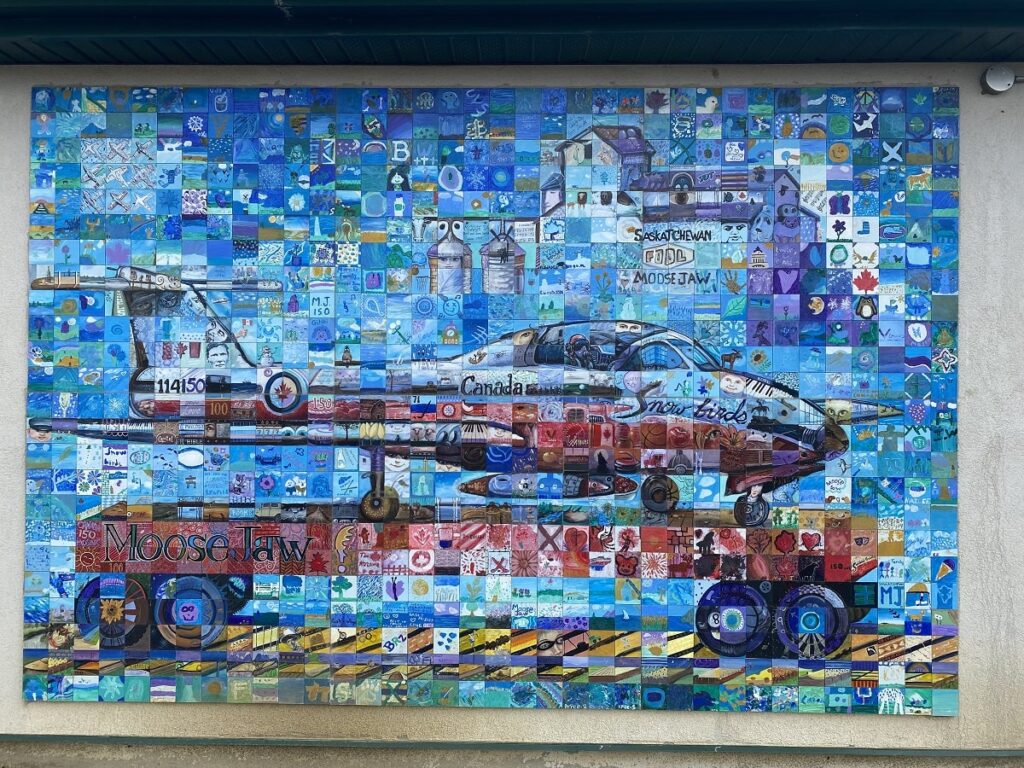 a mural of a small plane on a wall in Moose Jaw