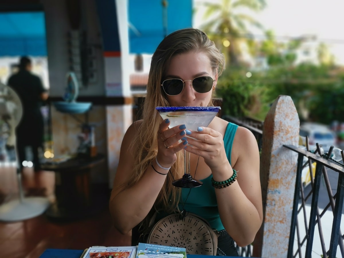 woman drinking a large margarita at Tuna Azul restaurant in Puerto Vallarta
