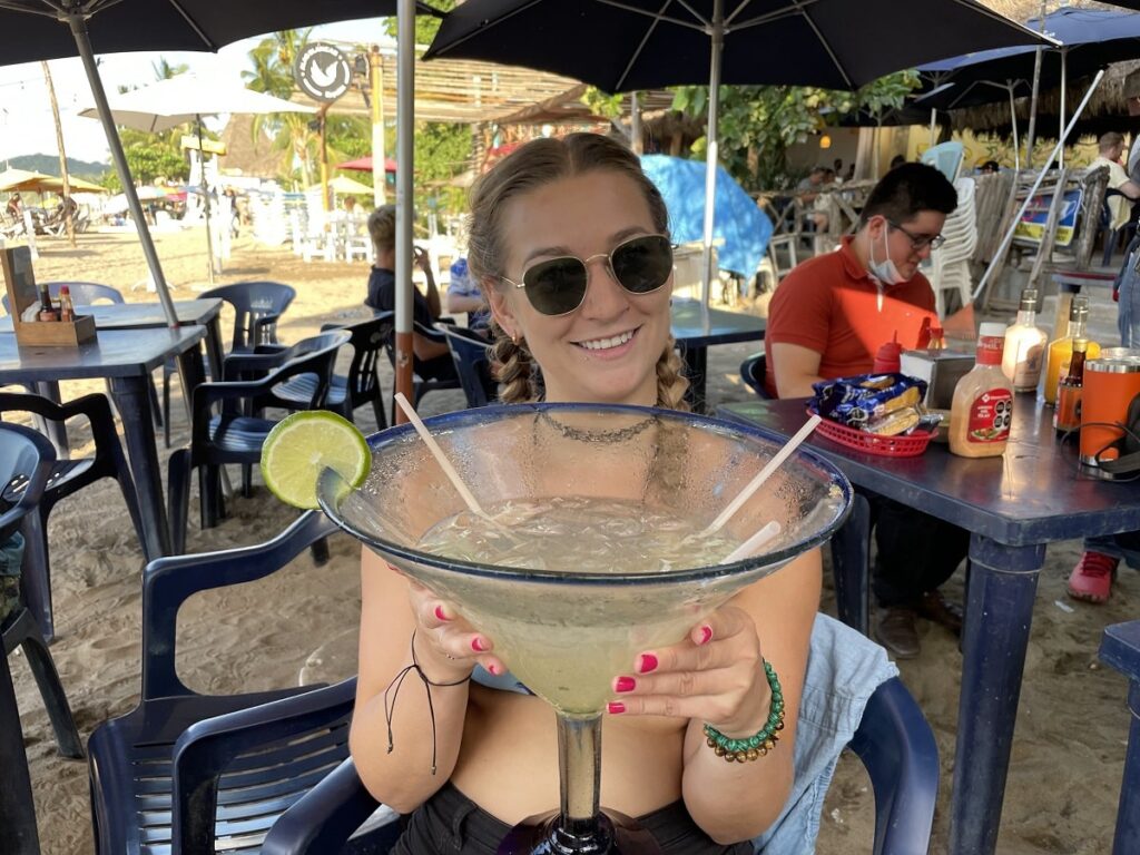 woman holding a huge maragarita in Sayulita, Mexico