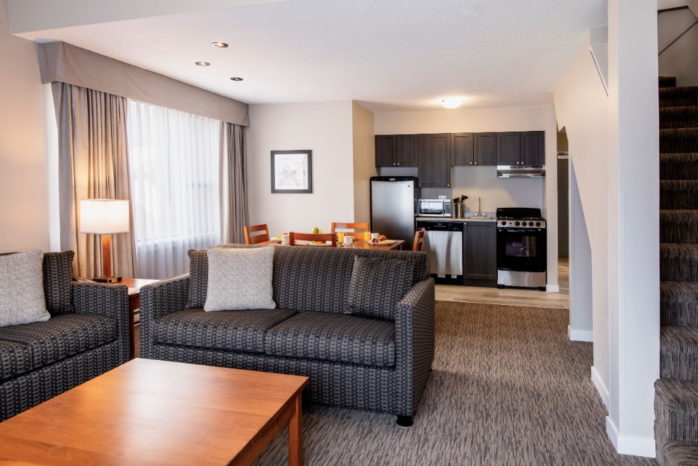 the kitche and living area in one of the apartments in Whistler Village Inn & Suites