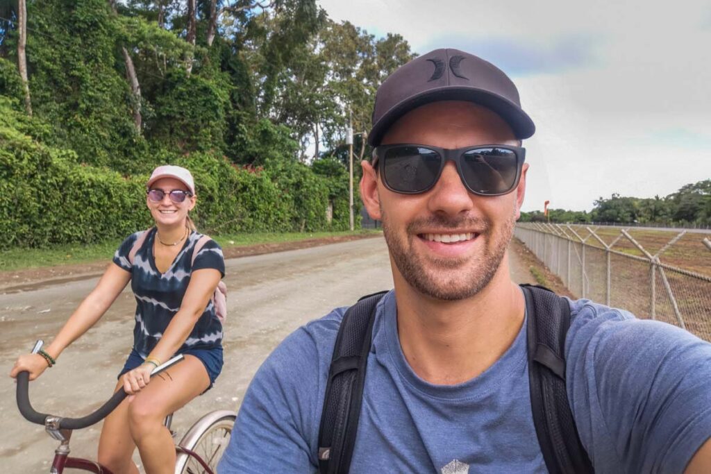 Bailey and Daniel from Destinationless Travel riding bikes through Puerto jimenez