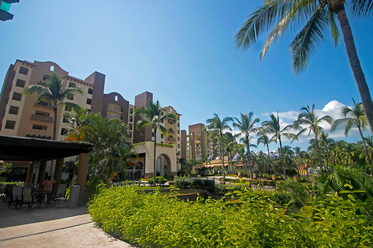 Villa del Palmar Flamingos Beach Resort exterior surrounded by palm trees.