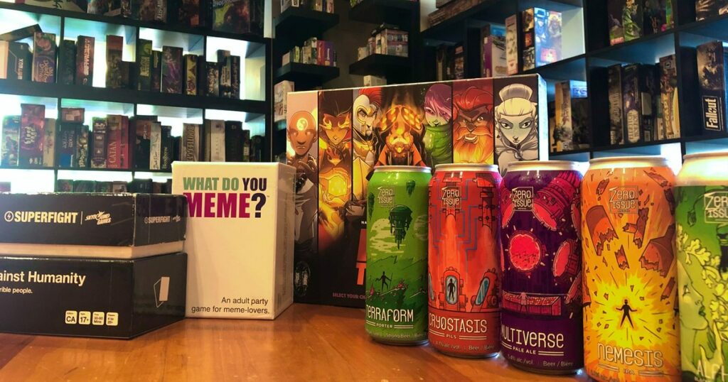 Round Table Board Gamerie games and cans of craft beer