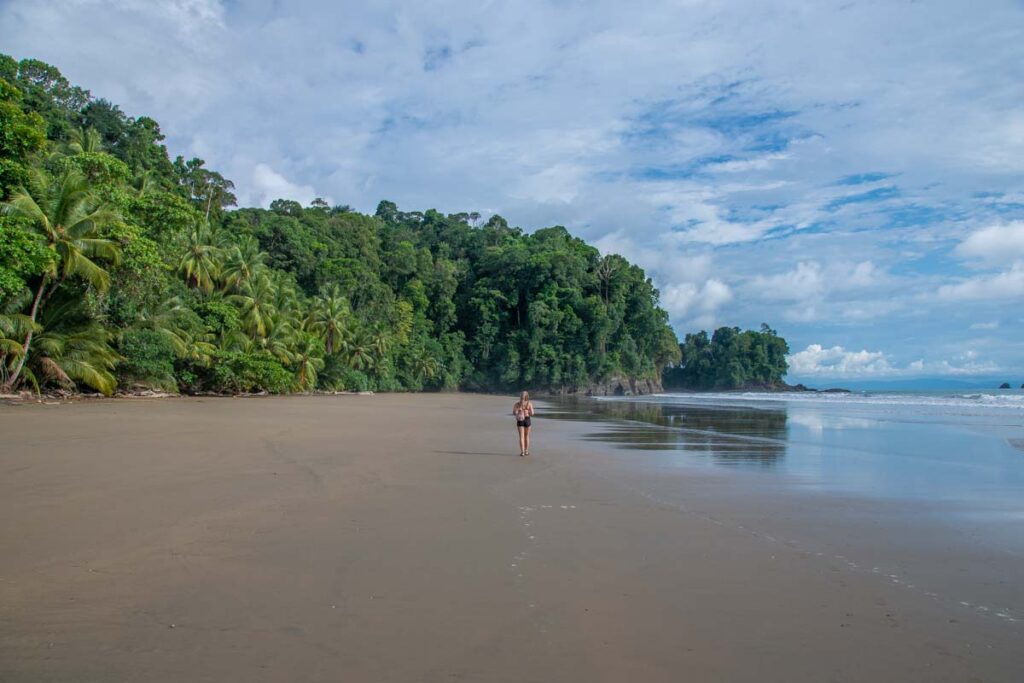 A lady walks along Arco Beach near Uvita Costa Rica