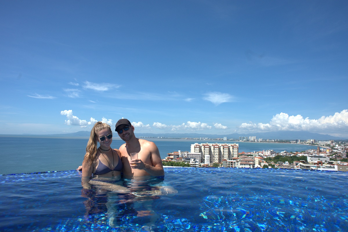 a couple in a rooftop pool overlooking Puerto Vallarta