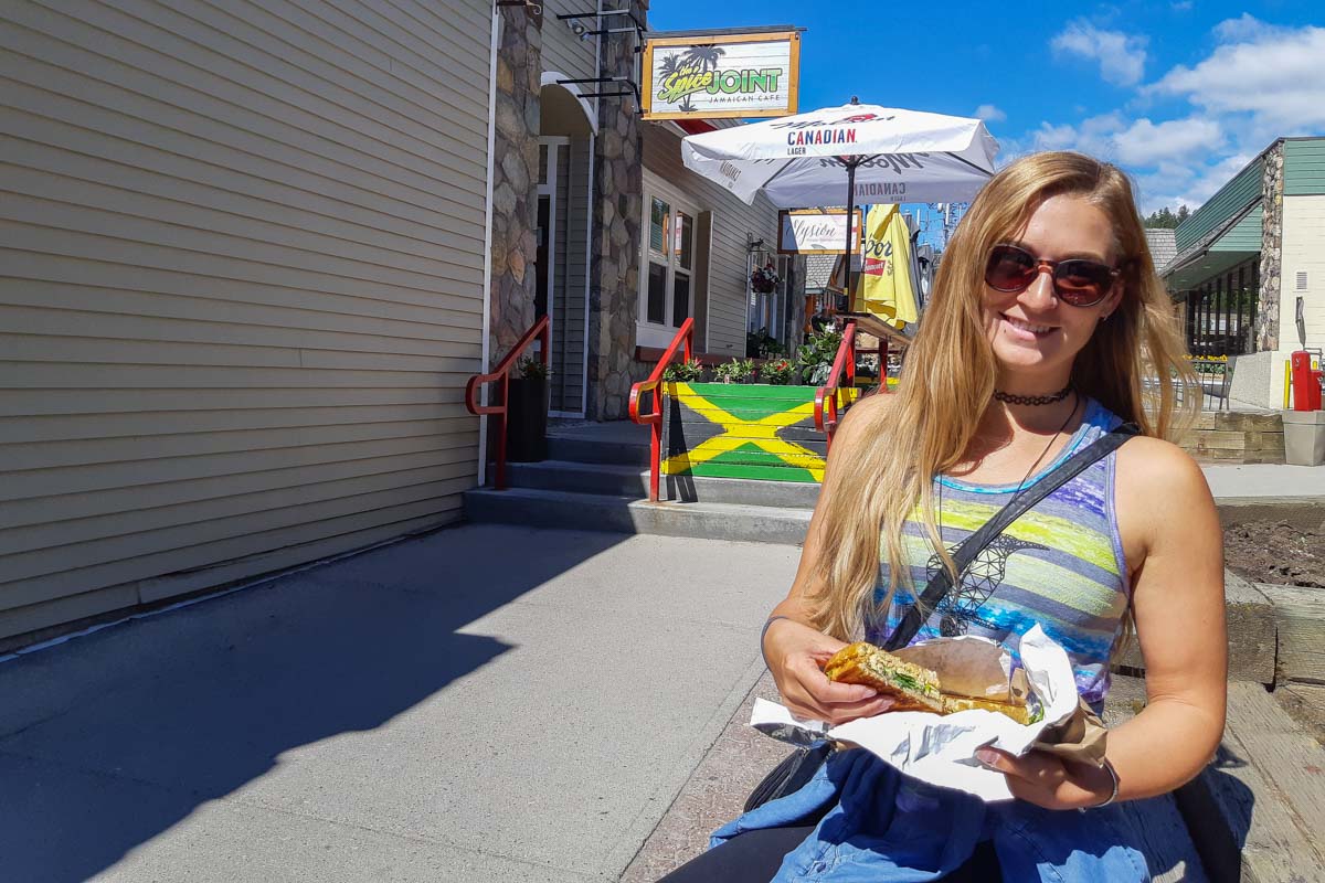A lady eats a sandwich in Jasper town