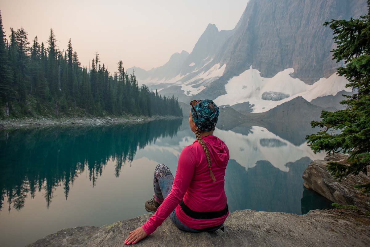 A lady sits at a Smokey Floe Lake