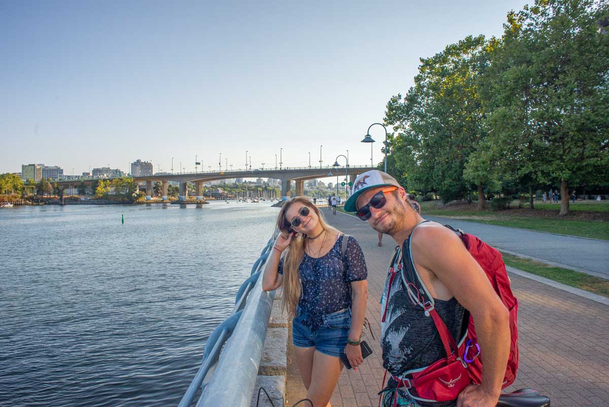 Two friends pose for a photo on the Vancouver Sea Wall