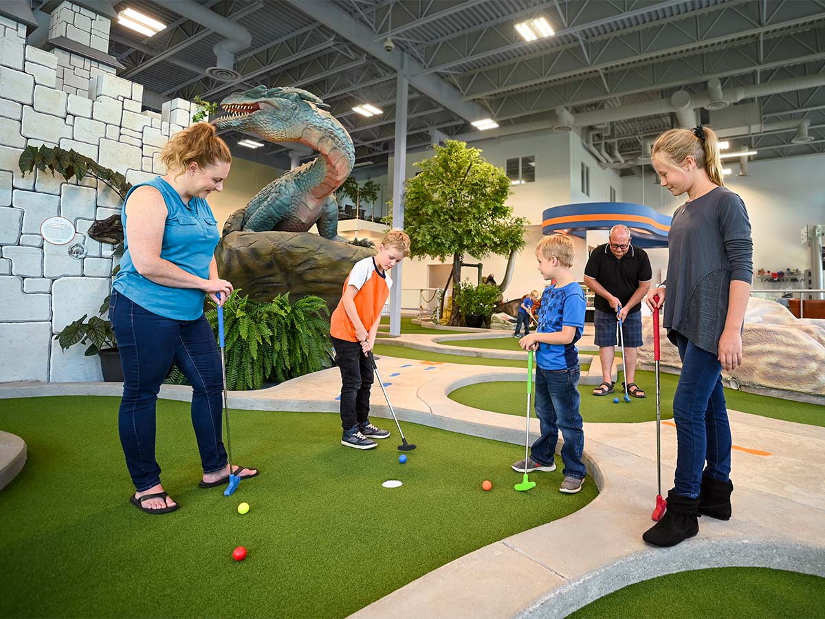 family playing minigolf at the DINO Centre in Innisfail