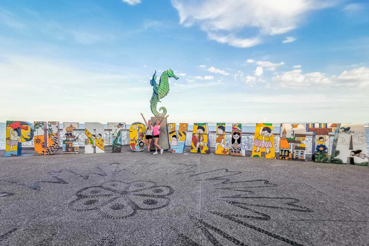 Two people pose for a photo on the Puerto Vallarta Malecon