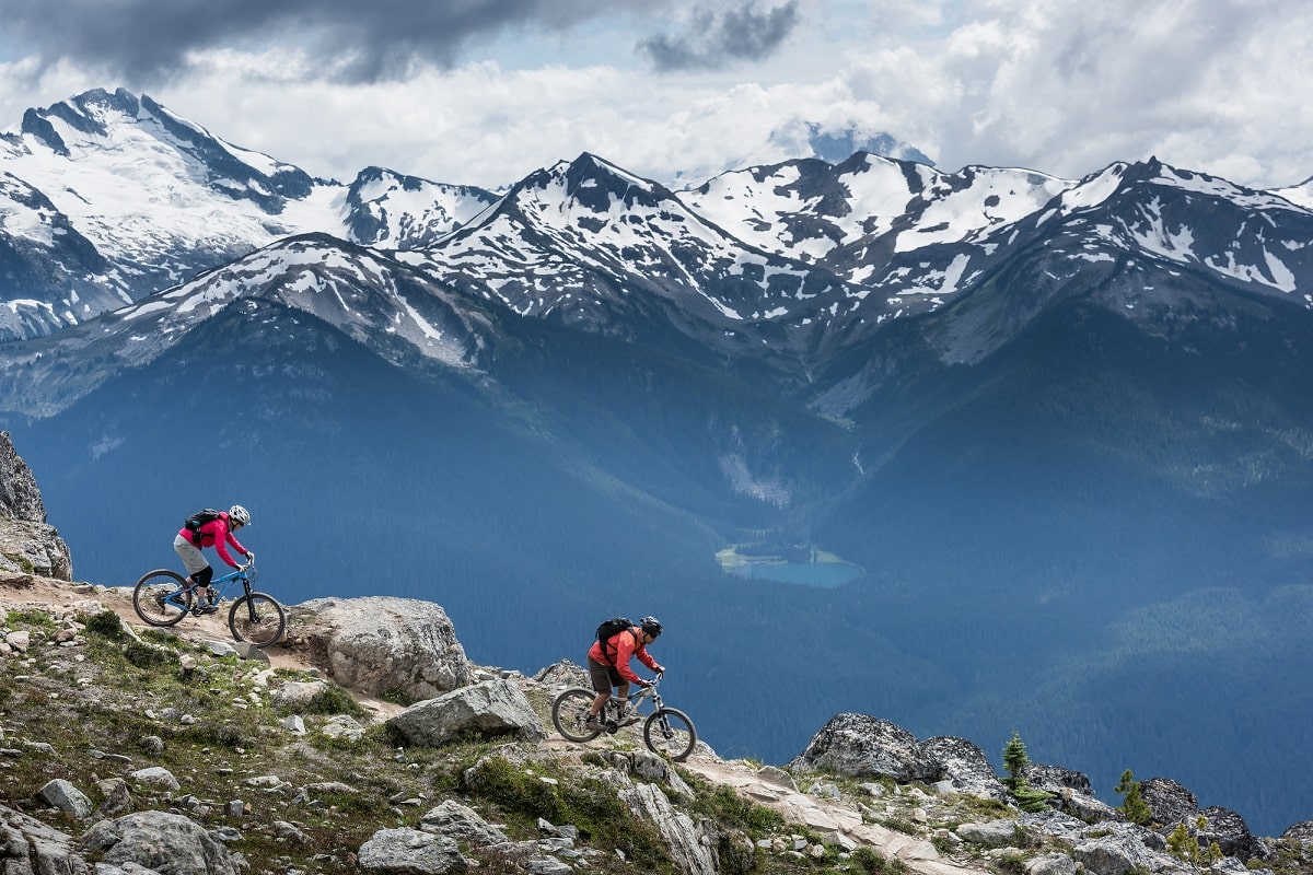 two mountain bikers riding a ridgeline in Whistler