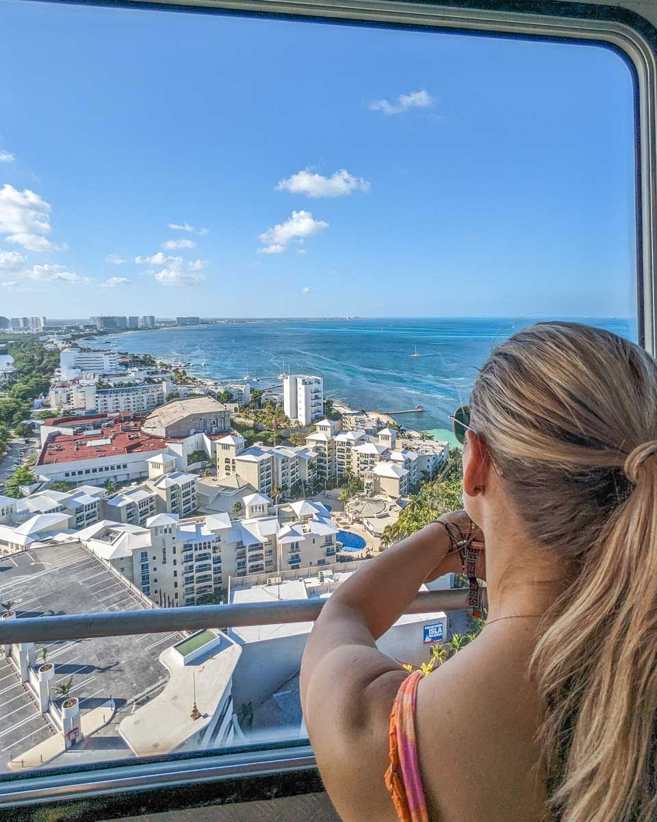 Bailey looks out the window of the Cancun Scenic Tower in Cancun, Mexico