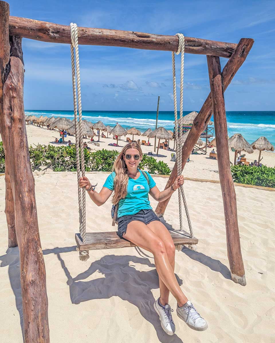 Bailey on a swing on Playa Delfines, Cancun, Mexico