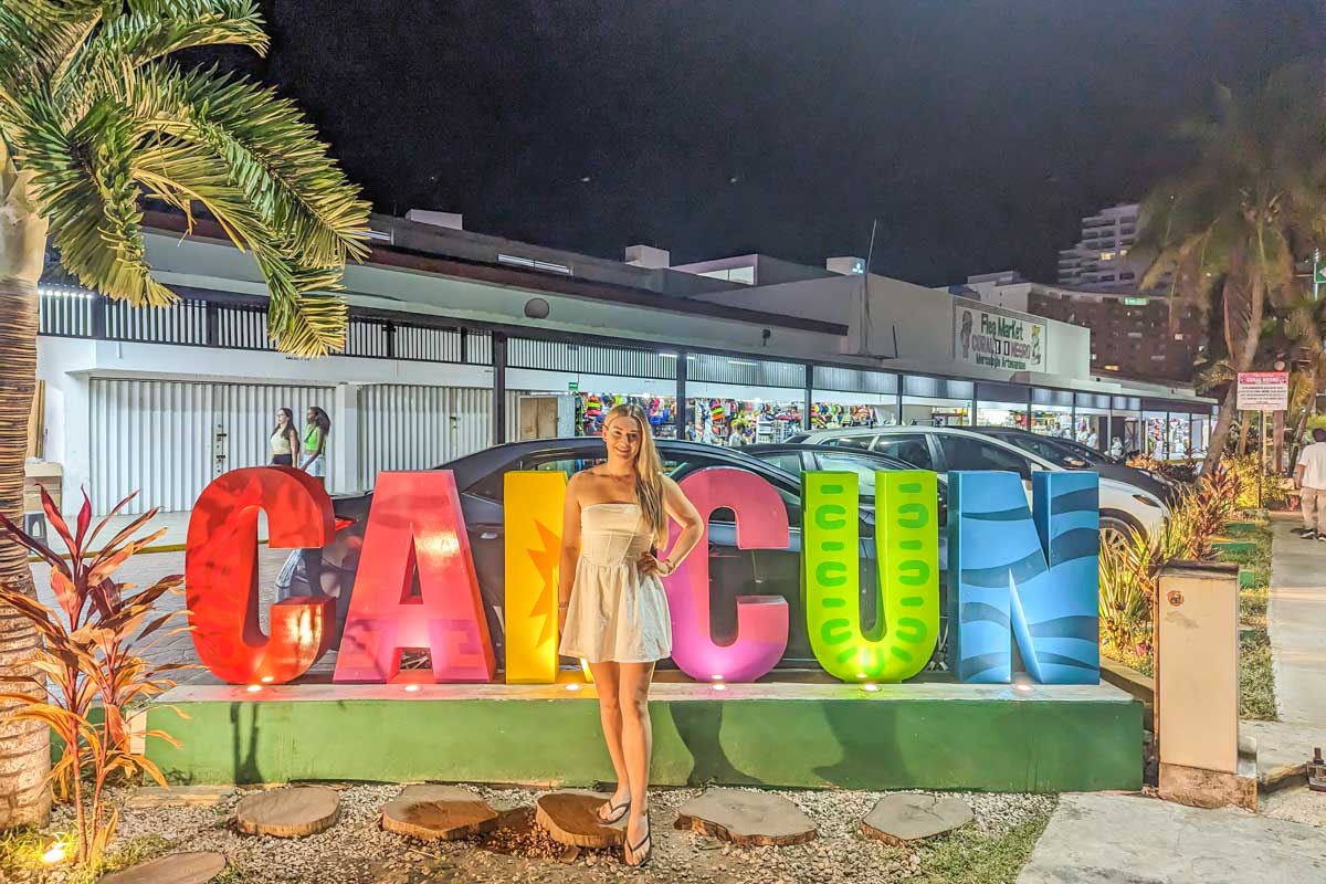 Bailey poses for a photo in front of one of the Cancun signs in Cancun, Mexico