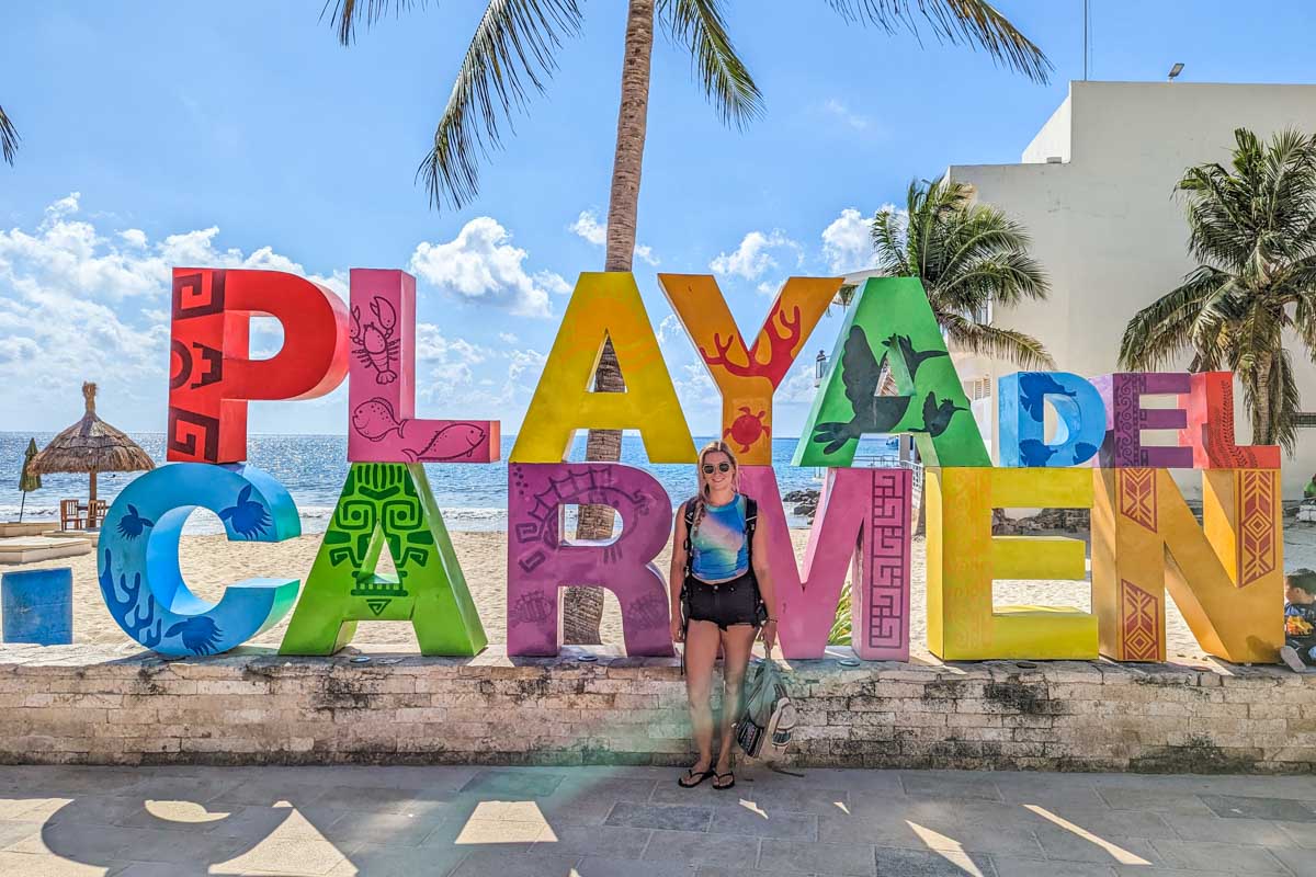 Bailey takes a selfie with the Playa del Carmen sign
