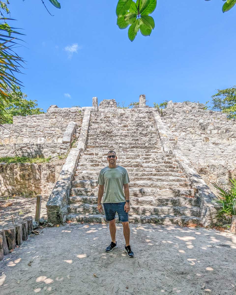 Daniel stands in front of the main temple at Zona Arqueológica de San Miguelito in Cancun, Mexico