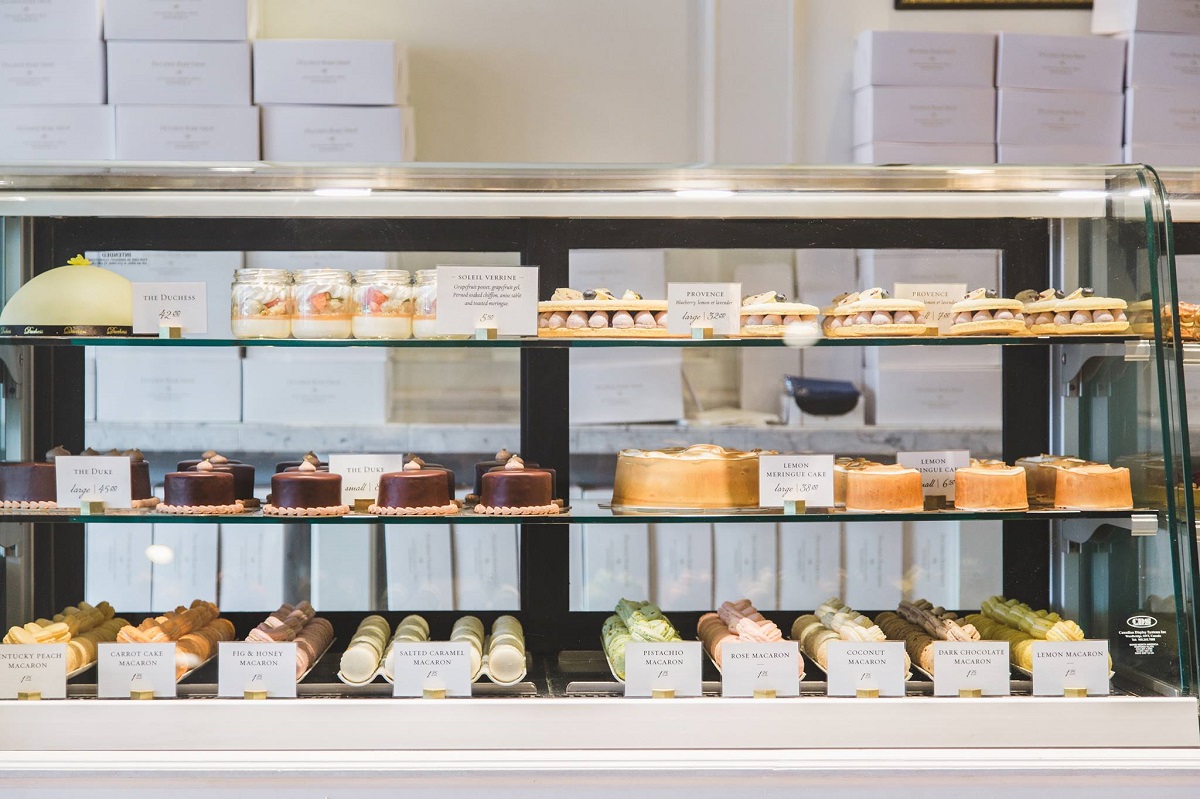 the display case at Duchess Bake Shop full of colorful small cakes and macaroons