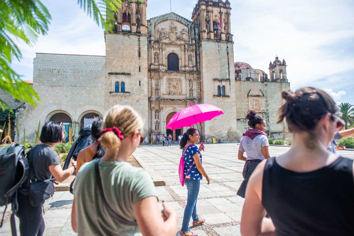 Following a lady on a free walking tour in Oaxaca, Mexico