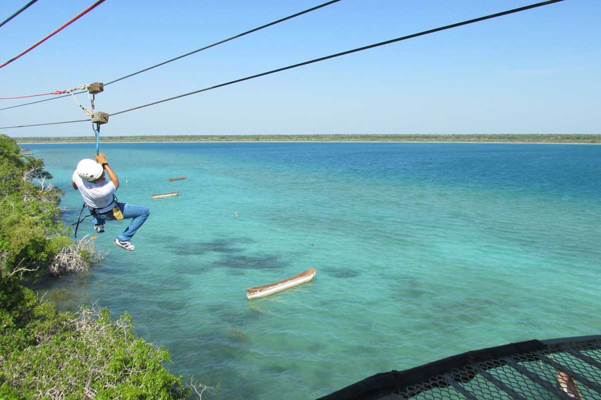 A man ziplines at Tirolesas Kan Kin Bacalar ziplining