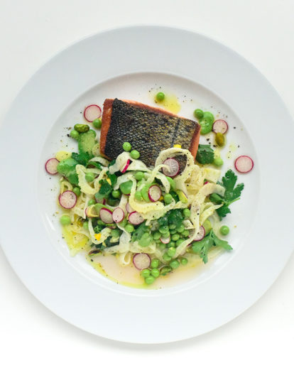 salmon on a dish plated with onions at Corso 32