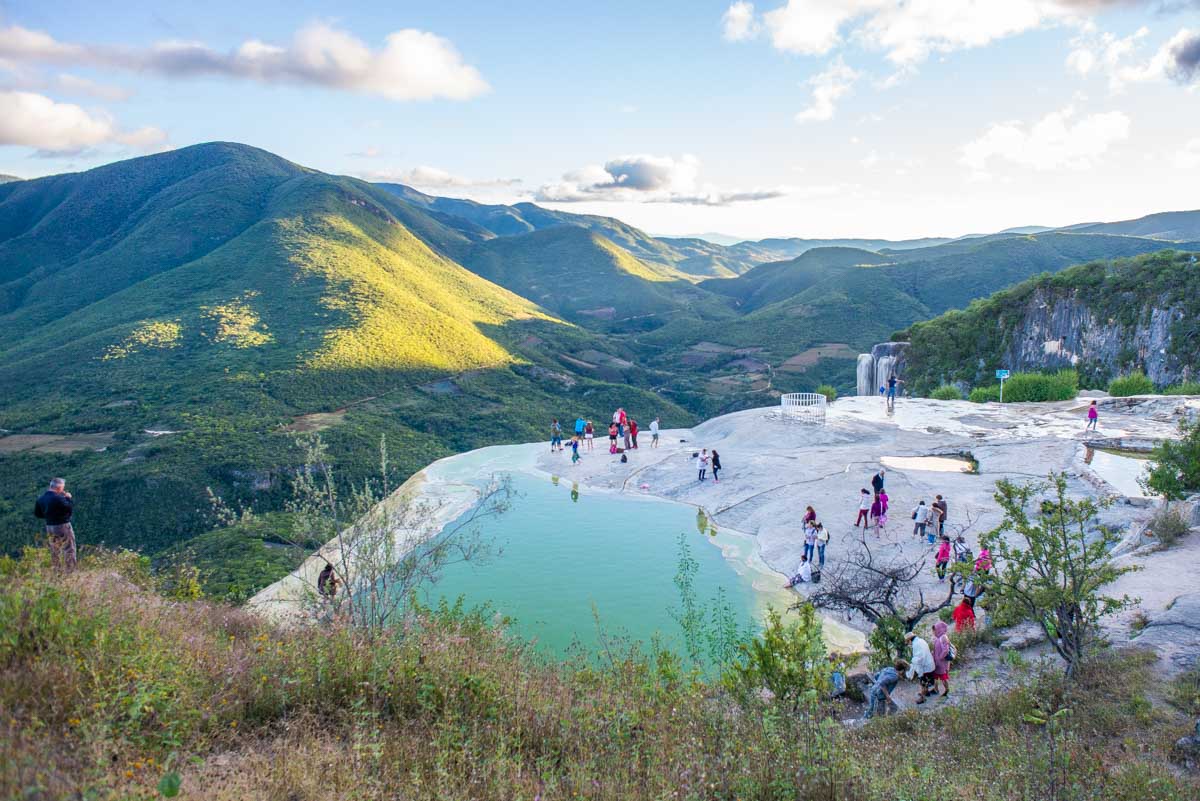 a tour group relaxes at the top of Hierve el Aqua in Oaxaca