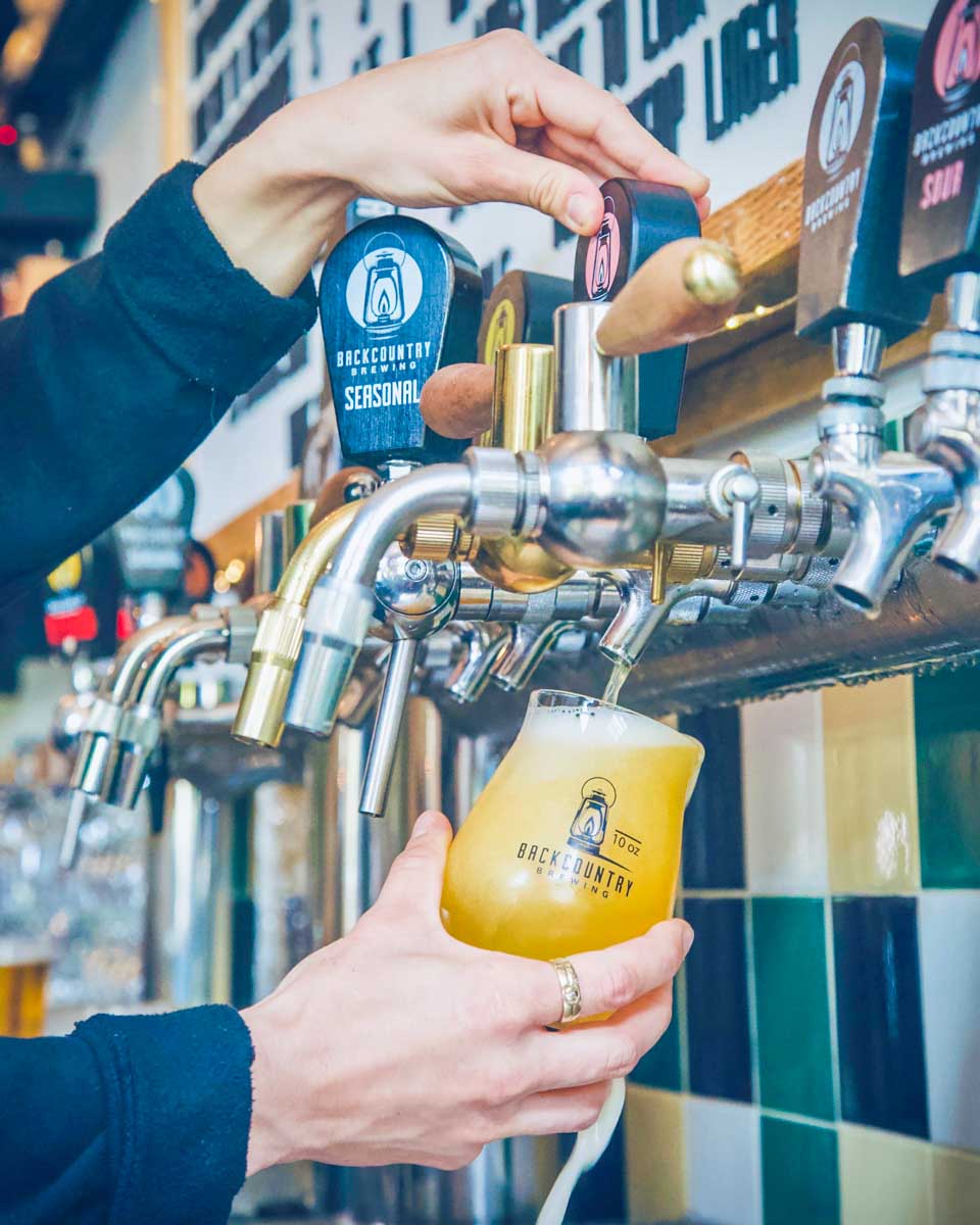 Backcountry Brewing Squamish, BC pours a beer from a tap