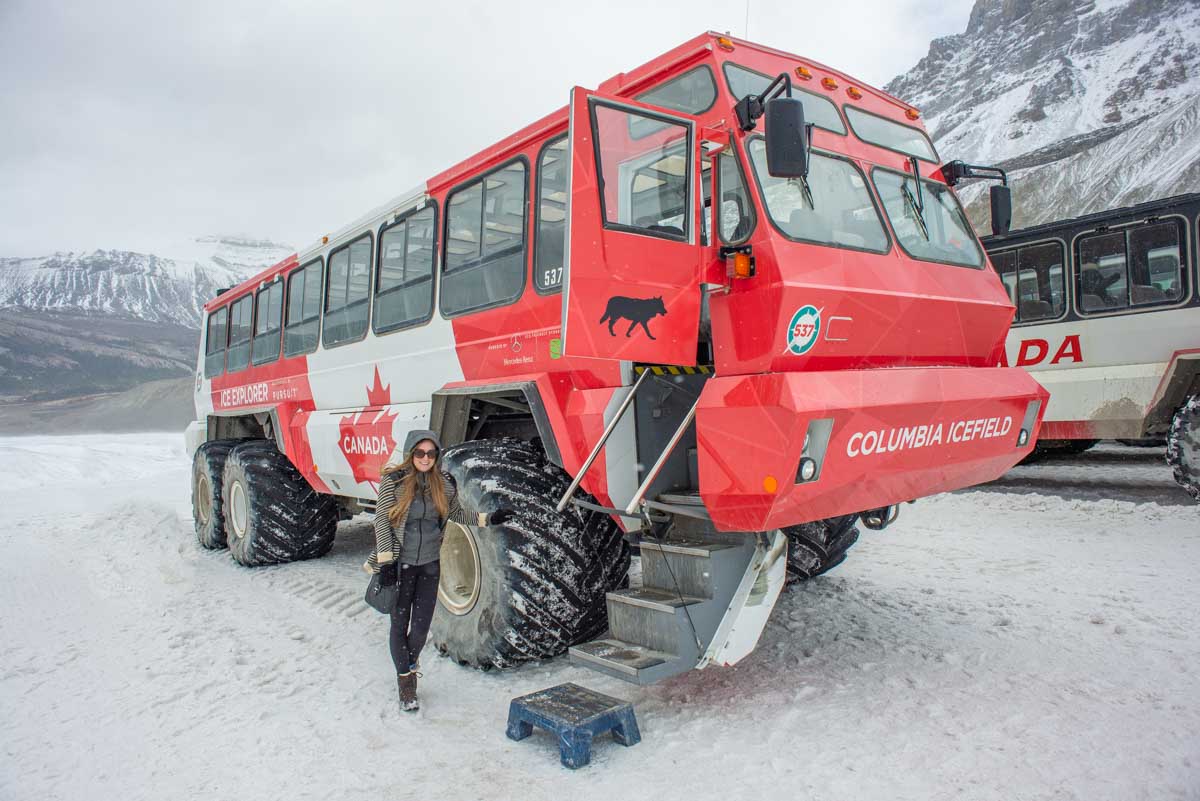 Bailey poses for a photo with an Ice Explorer all-terrain vehicle on the Athabasca Glacier in the Columbia Icefield, Canada