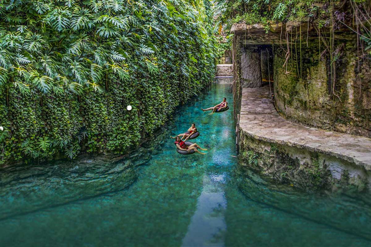 Three people float down a river at Cenotes Hacienda Mucuyché