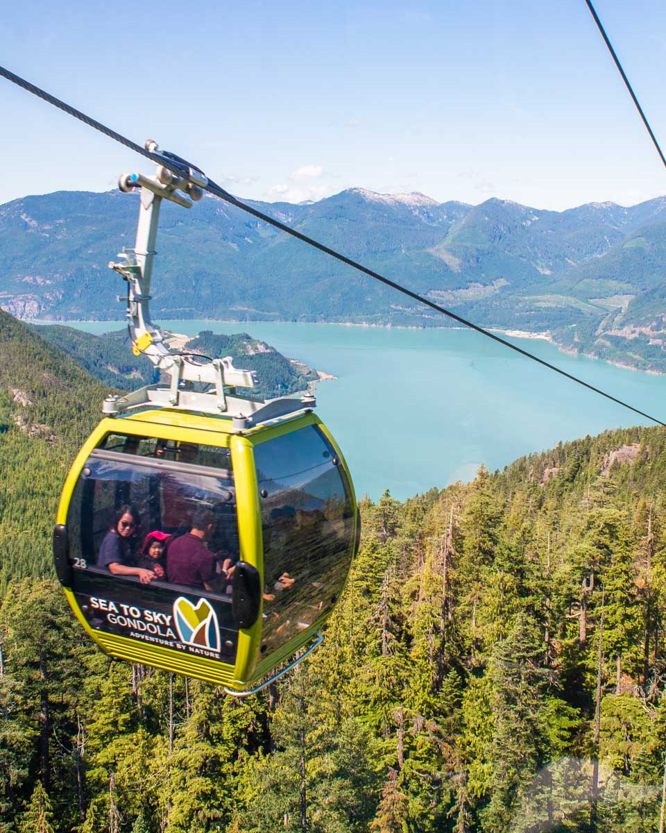 A carriage on the Sea to Sky Gondola makes it way up the mountain with views of Howe Sound in the background near Squamish, BC