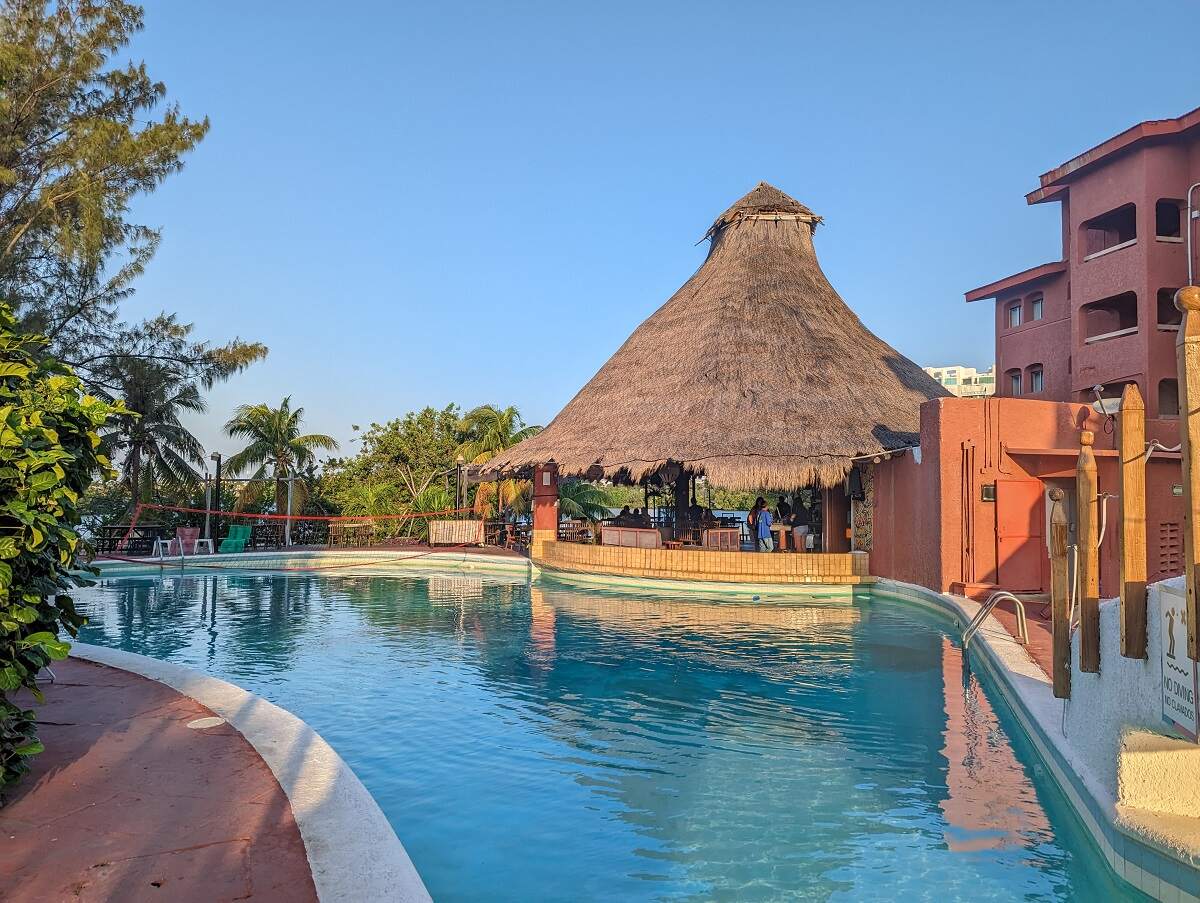 the pool and bar at sunset at the Selina Cancun