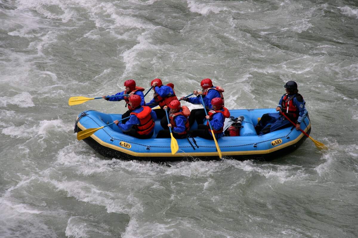 group of people whitewater rafting down the river in Clearwater, BC