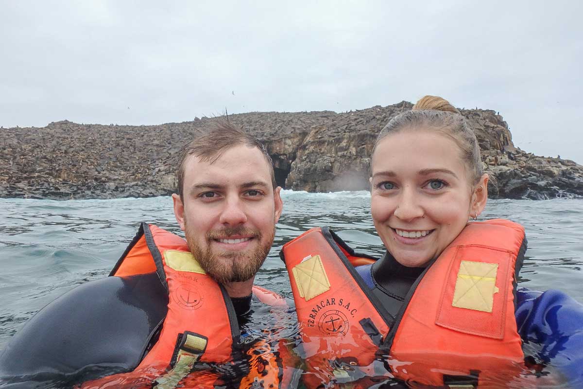 Bailey and Daniel take a selfie while swimming with sea lions in Lima