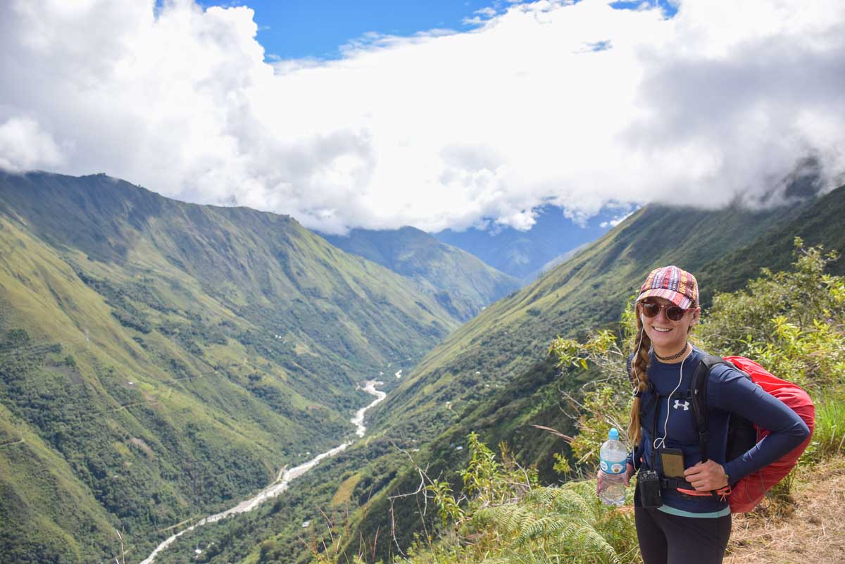 Bailey takes a photo overlooking a valley on the Salkantay Trek, Peru