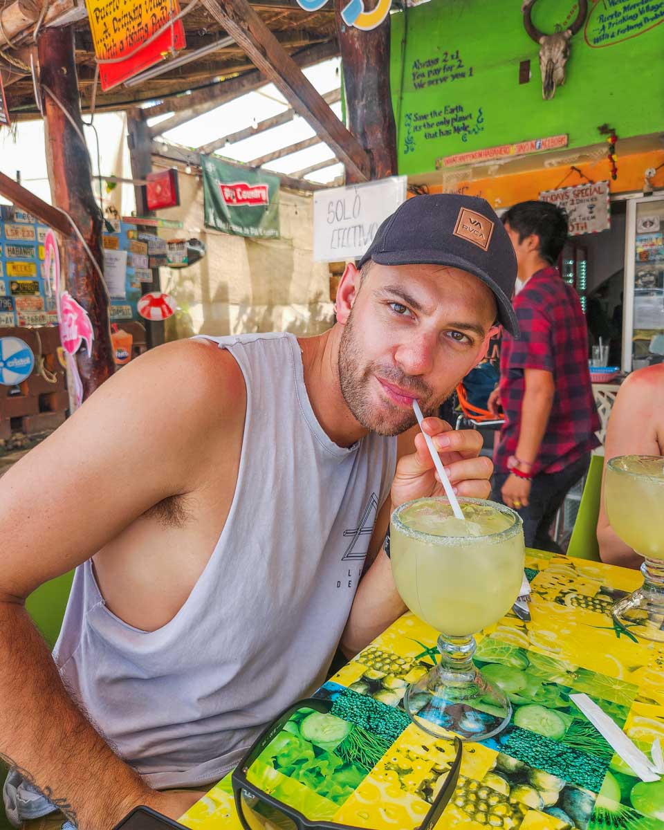 Daniel drinks from a cocktail at Cantina Habenero in Puerto Morelos