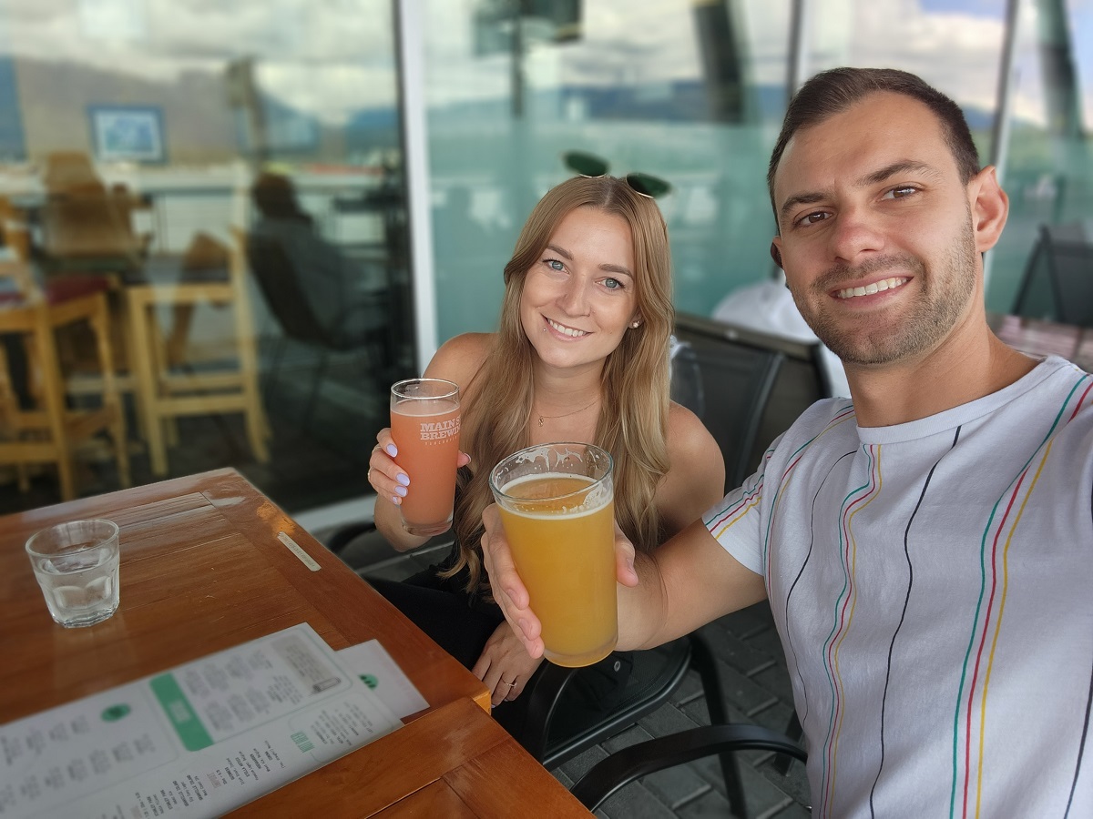 couple takes a selfie with beers in a restaurant