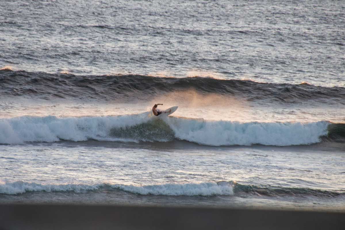 A man surfing the waves at Surfers Point in Margaret River, Western Australia