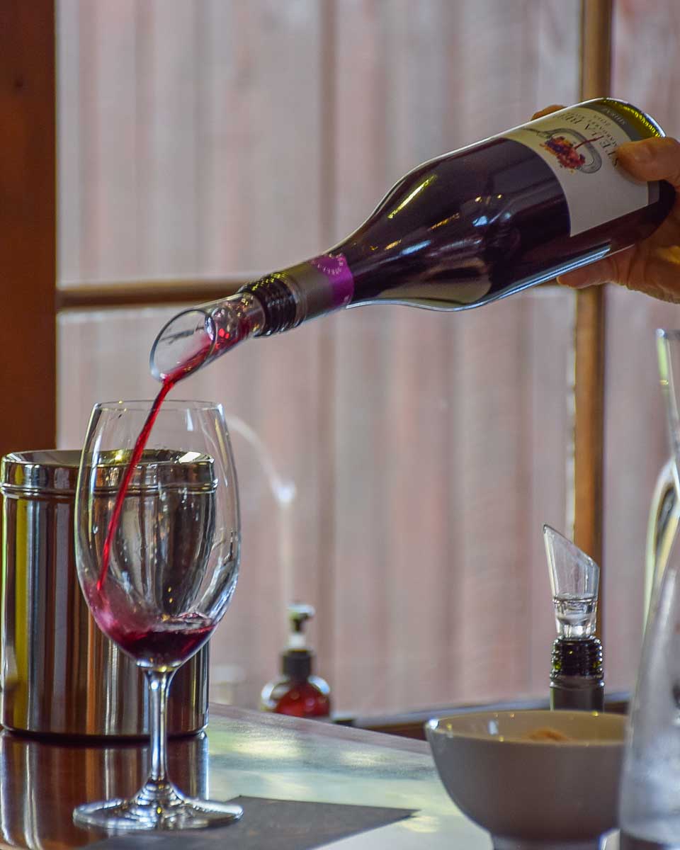 A server pours a glass of wine on a wine tour in Margaret River, Western Australia