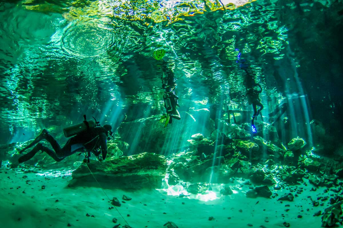 People scuba diving in a Tulum Cenote